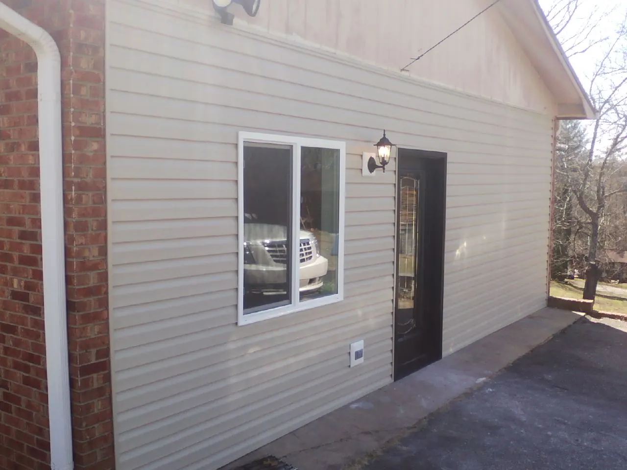 New vinyl siding and entry door on a room addition in Harwinton