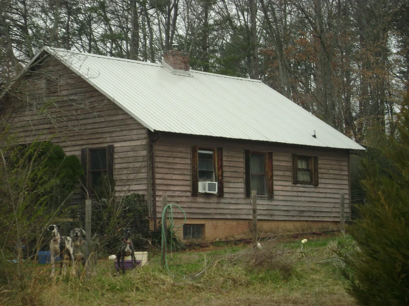 White metal roof on an old wood sided farmhouse, from a Metal Roof Installation job in Harwinton